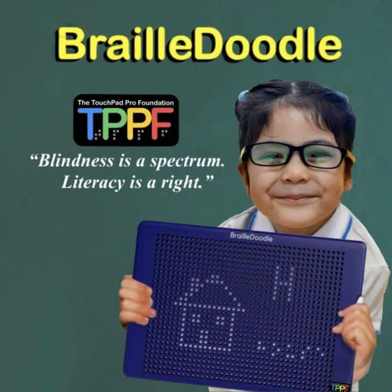 a girl about 5, in a white blouse and black and yellow glasses, is smiling. She is holding the BrailleDoodle. On the surface are a house, a capital letter H, and the word house in braille. A quote says, "I made this!" Are the word braille doodle appears in bright yellow letters, the touch pad pro foundation logo, and blindness is a spectrum literacy is a right. in quotation marks