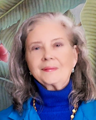 Women with long gray hair in a blue turtleneck and jacket